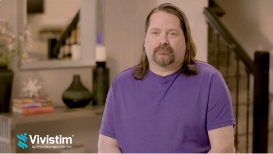 Dave sits in a living room giving his stroke recovery testimonial